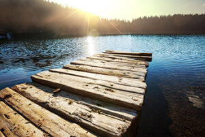 Lake with dock at sunset