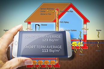 Hand holding portable device for measuring radon gas with home illustration in the background