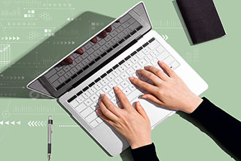 Hands typing on laptop computer